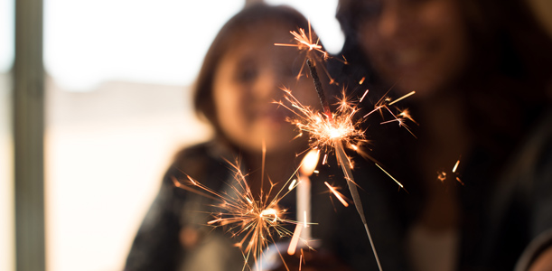 Mother and daughter holding a sparkler